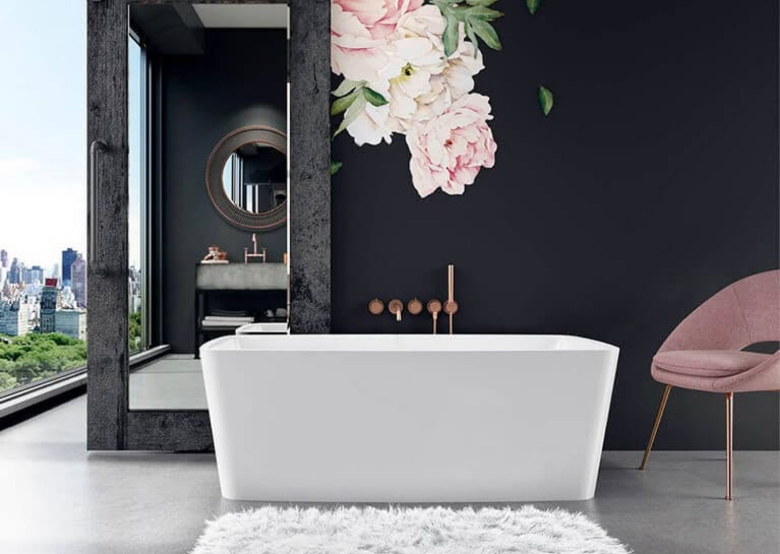Modern bathroom with white freestanding tub, large mirror, pink chair, floral wall decal, and city skyline view.